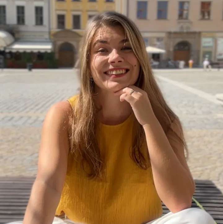 Weronika Szumiel, Polish teacher, sitting in Wrocław's Market Square