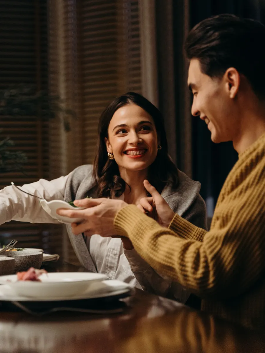 Couple smiling at each other at the dinner table