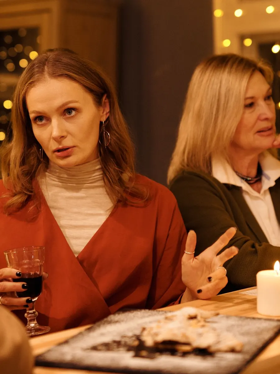 Young woman and her mother listening at a candlelit table